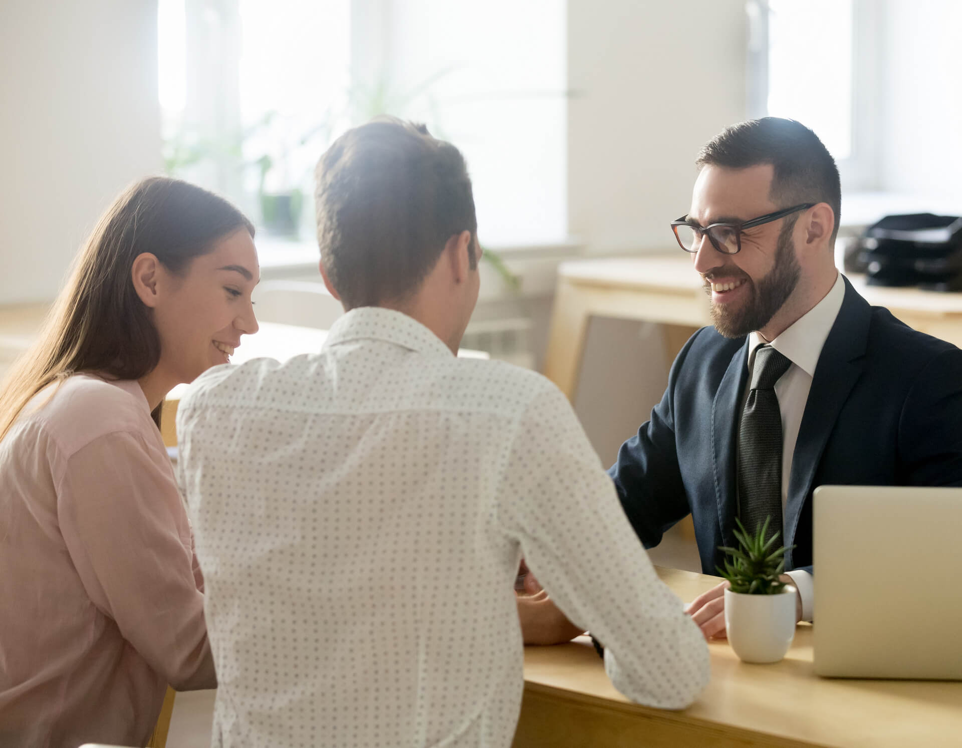 A young couple meeting with a financial planner.
