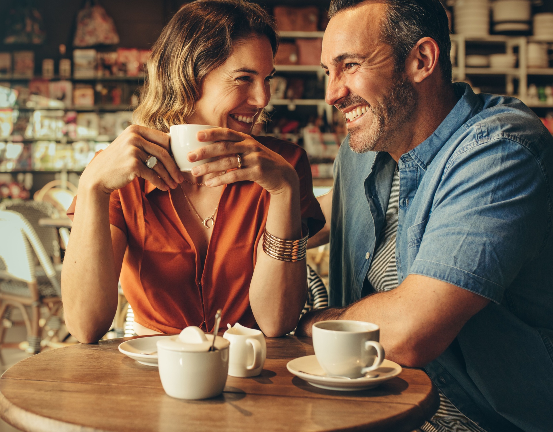 A couple laughing in a café.