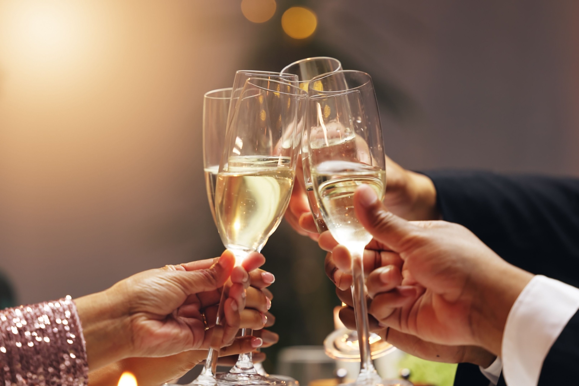 A group of people clinking champagne glasses.
