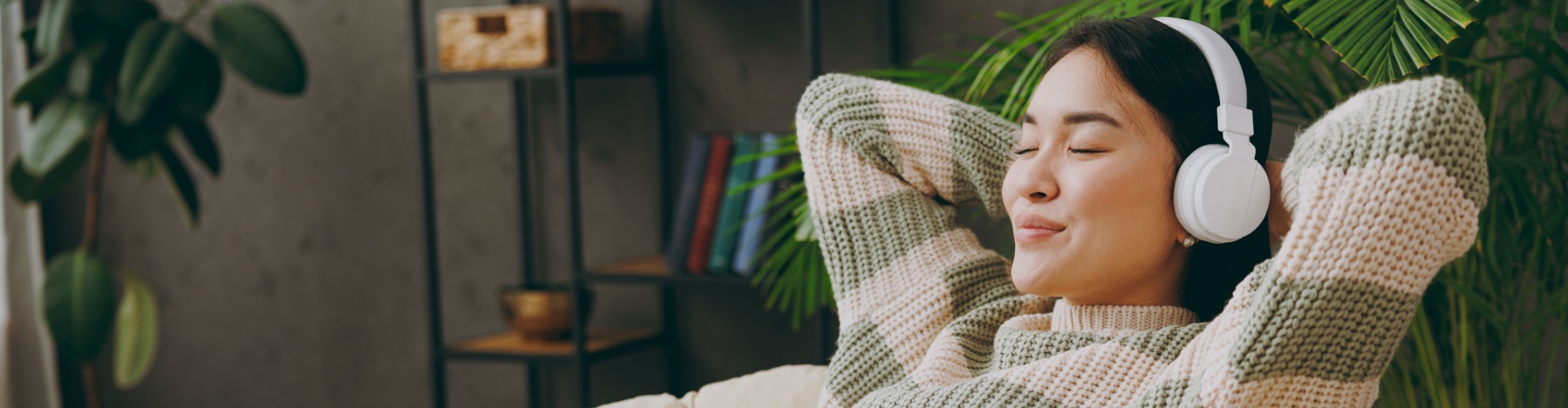 A woman relaxing with headphones on.
