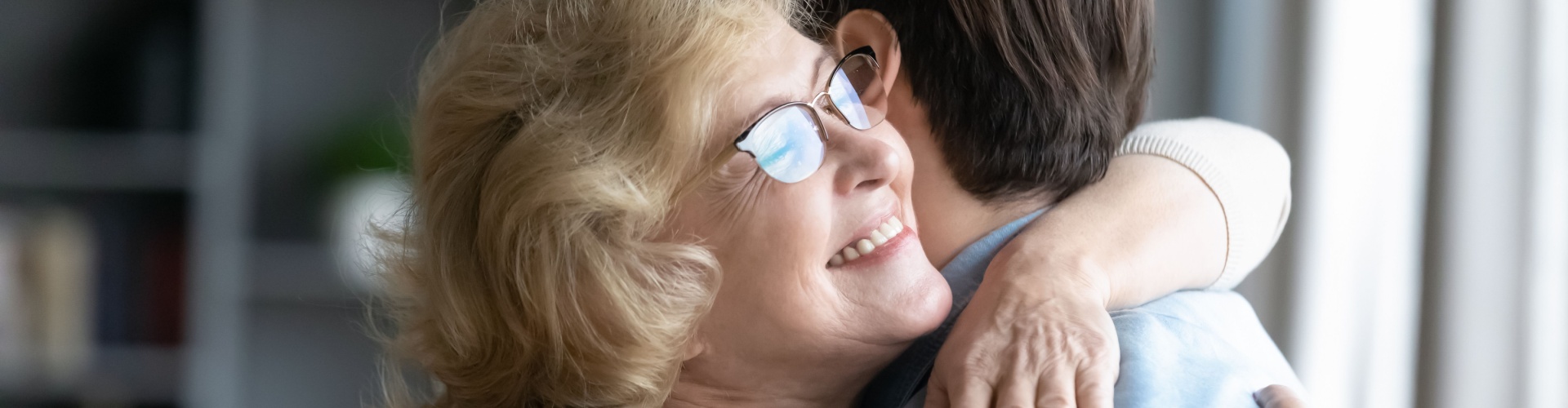 A mother hugging her adult son.