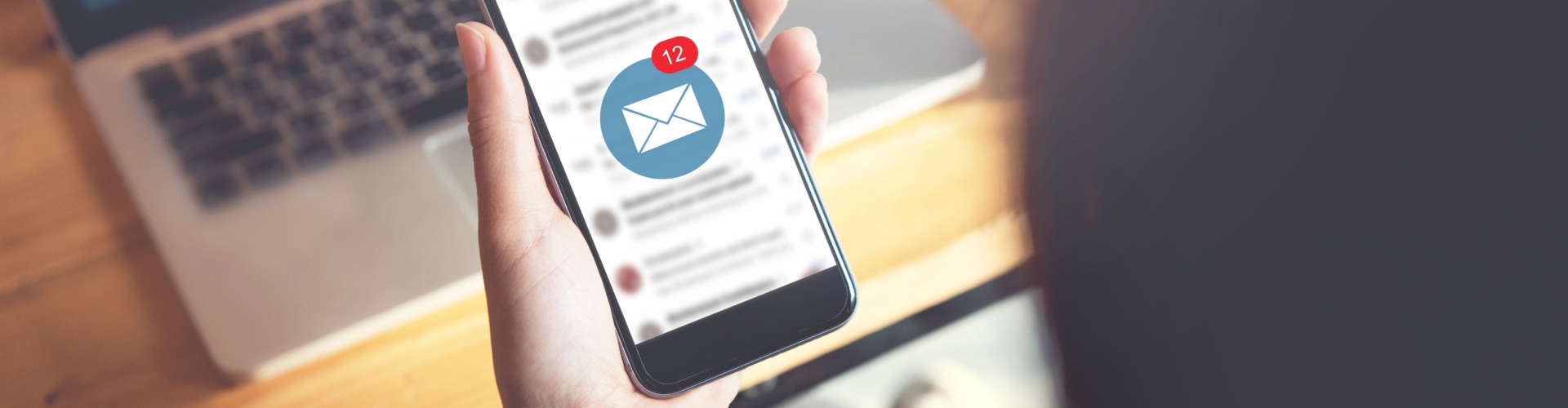 A person looking at their email on their phone.