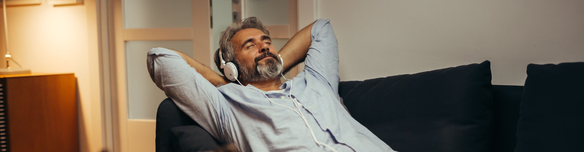 A man relaxing while listening to music.