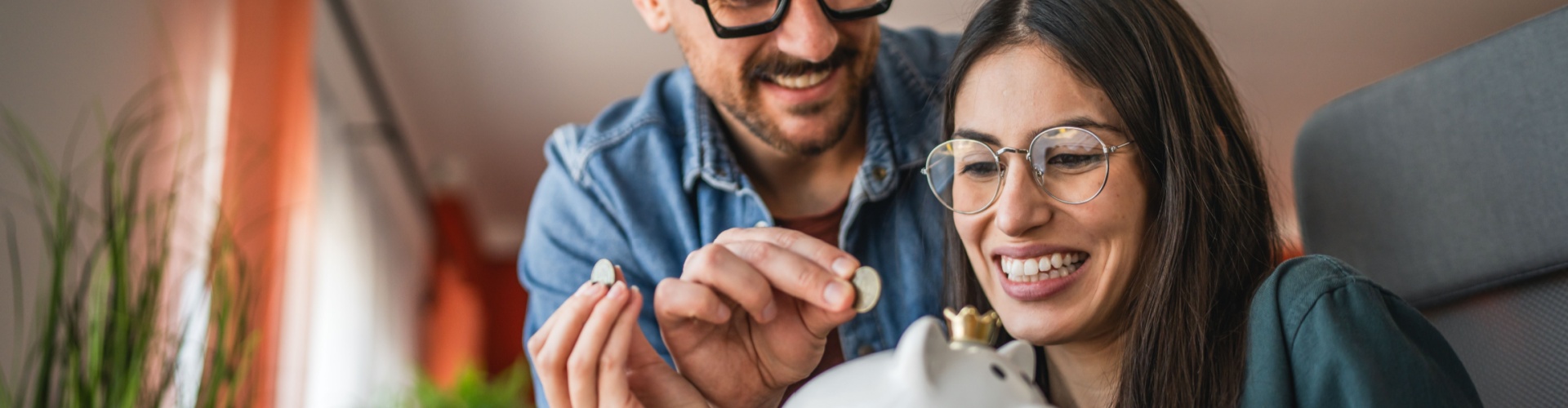 A couple saving in a piggy bank.