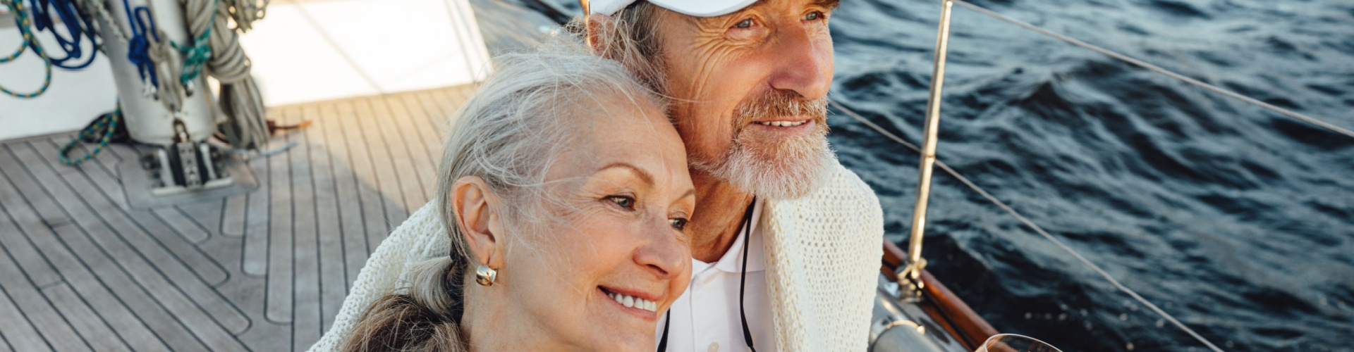 A couple sitting on a yacht deck.