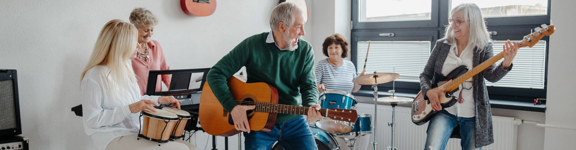 A group of people in their 50s playing musical instruments in a band.