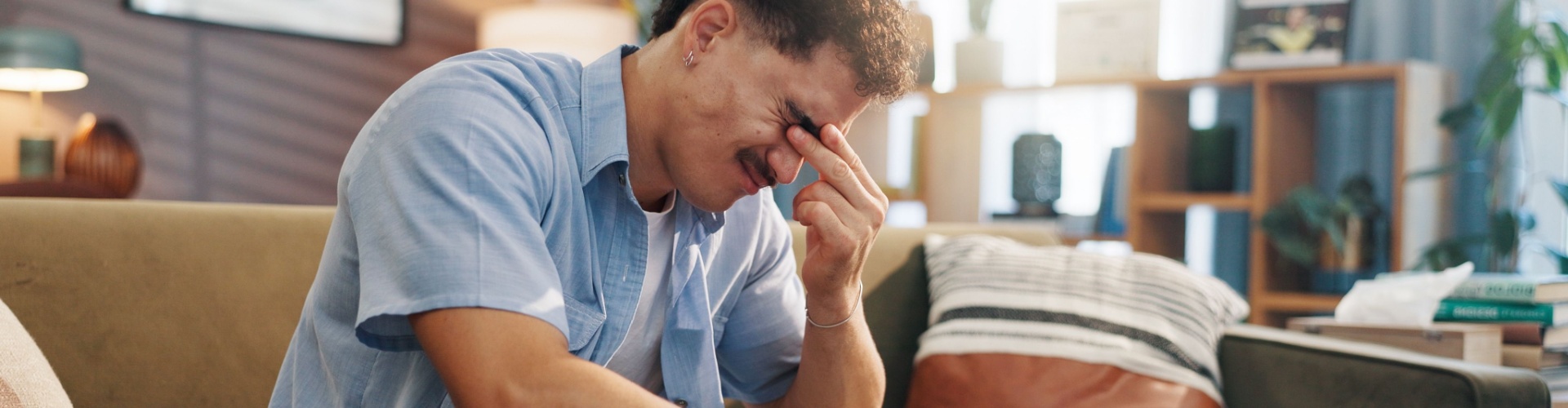 A stressed man with his head in its hand.