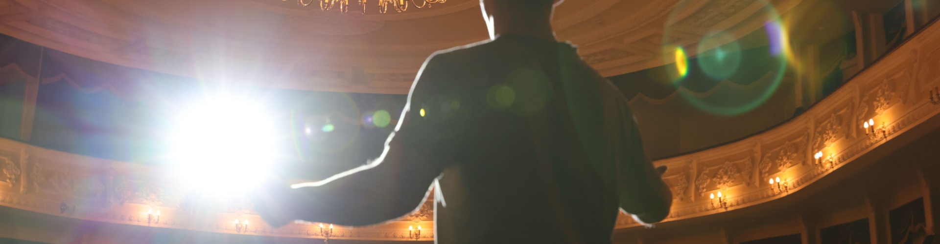 An actor rehearsing on a theatre stage.