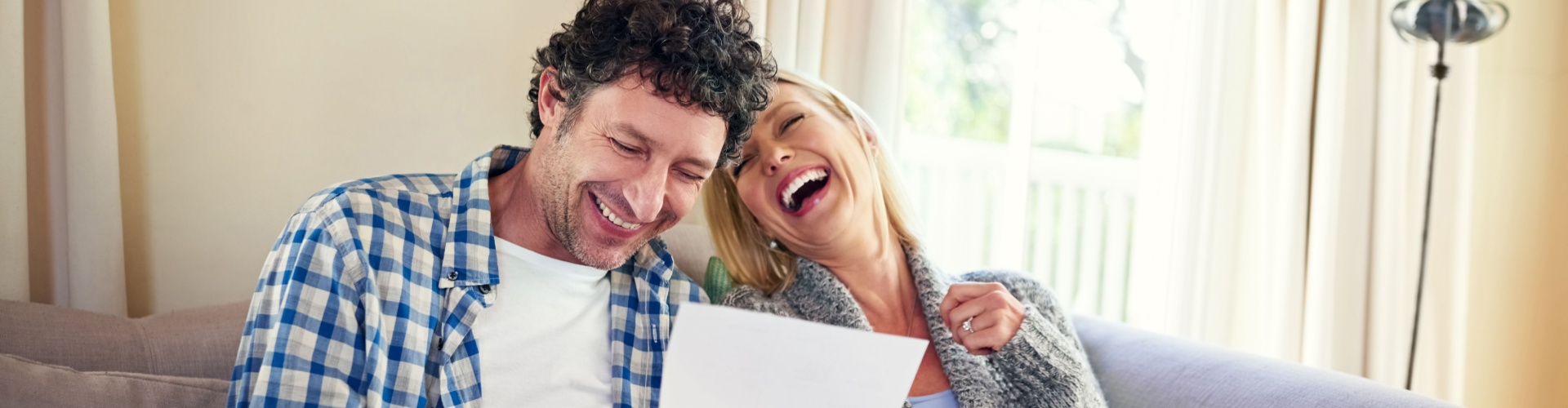 A happy couple reviewing paperwork.