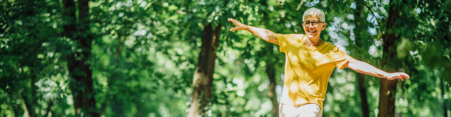 A woman doing balancing exercises outdoors.