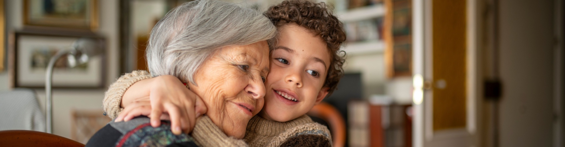 A woman hugging her grandchild.