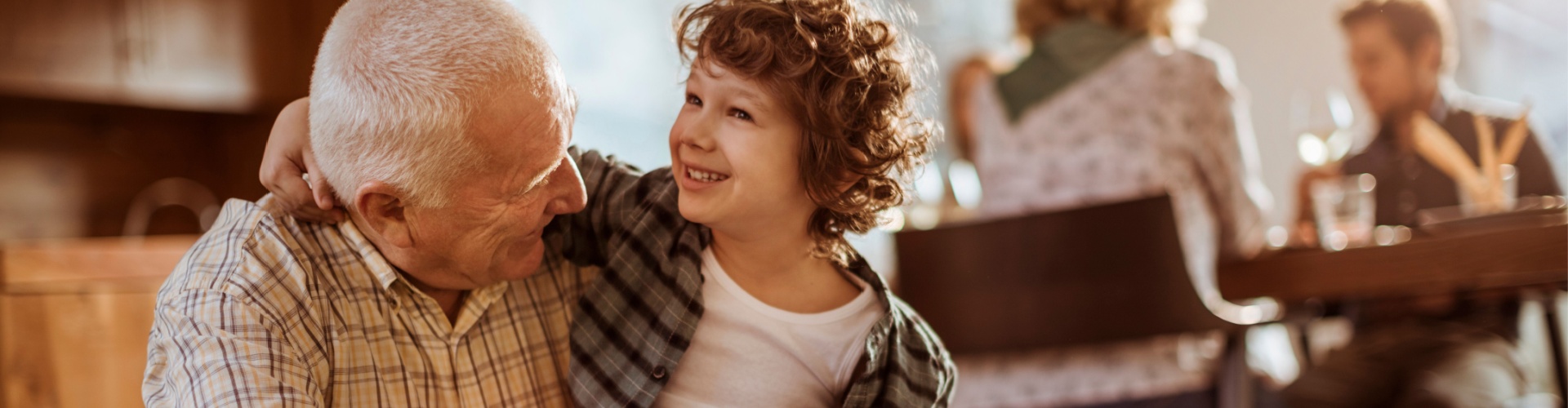 Grandfather hugging his grandchild.