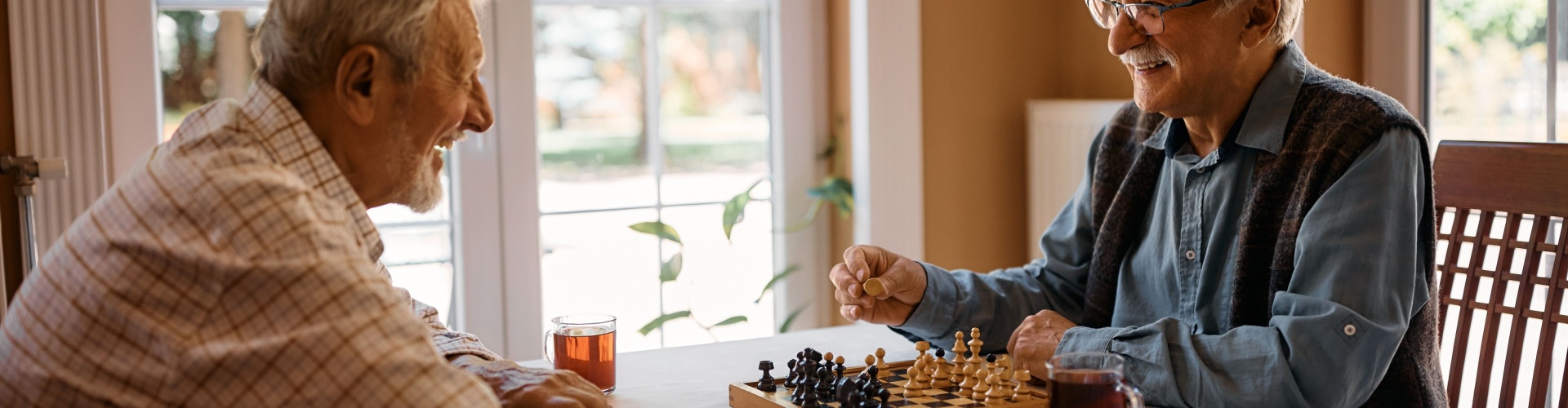 Two men playing chess at home.