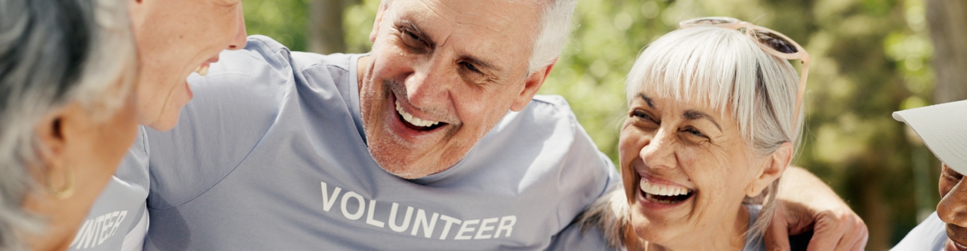 Happy senior people wearing “volunteer” t-shirts