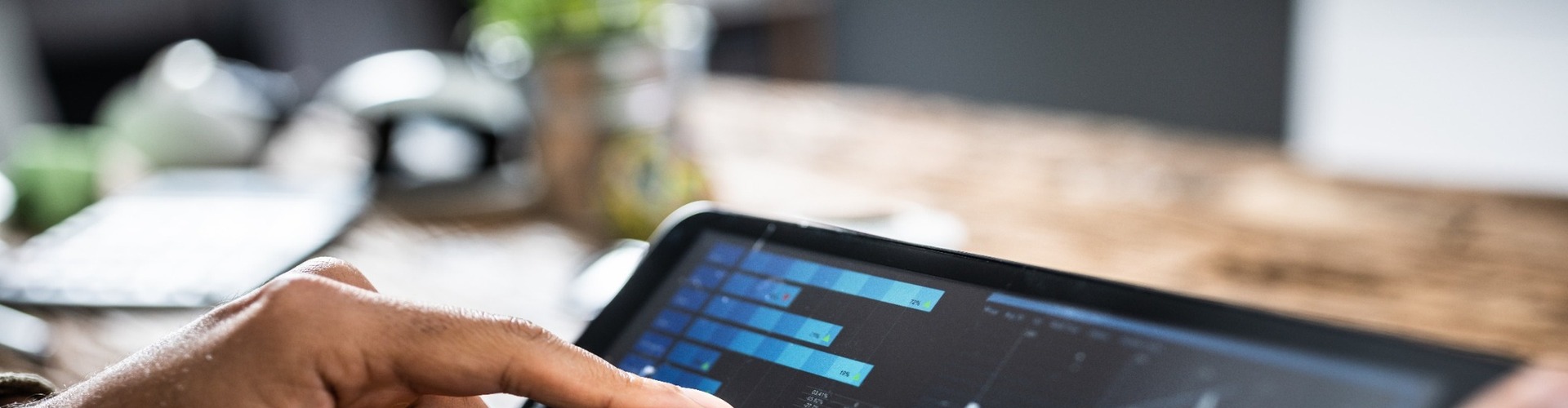 A person reviewing investment performance on a tablet.